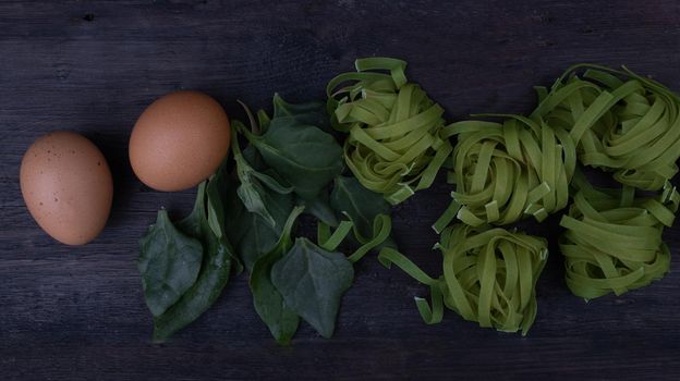 kitchen background with noodles and spinach leaves