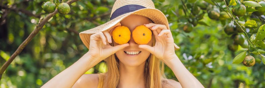 BANNER, LONG FORMAT Portrait of Attractive Farmer Woman is Harvesting Orange in Organic Farm, Cheerful Girl in Happiness Emotion While Reaping Oranges in The Garden, Agriculture and Plantation Concept.