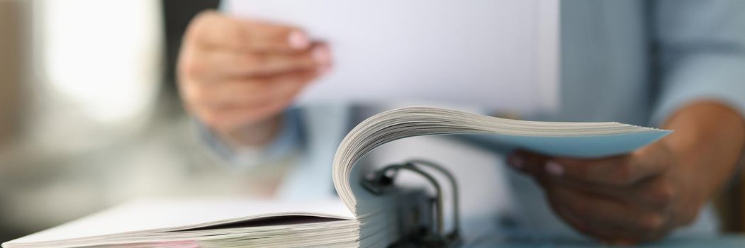 Business woman in suit looking documents from folder closeup. Business development concept