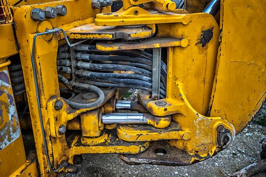 Detail of modern yellow excavator machines. Close up
