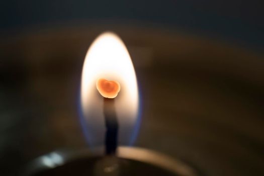 The red heart inside in candle flame, extreme macro