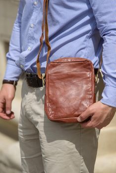 close-up photo of orange leather bag . street photo