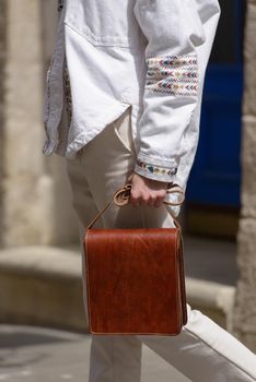 close-up photo of orange leather bag . street photo