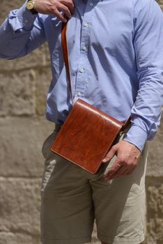 close-up photo of orange leather bag . street photo