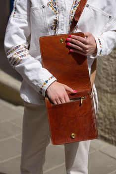 close-up photo of orange leather bag . street photo