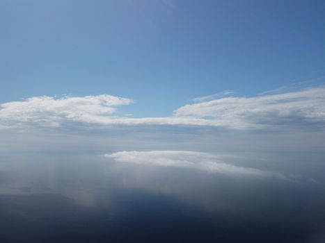 Footage B roll Aerial view drone flying above white clouds dense fog move quickly. Drone flies high back in blue sky through fluffy clouds. Beautiful foggy and cloudy slow moving Aerial view. Fog sea.
