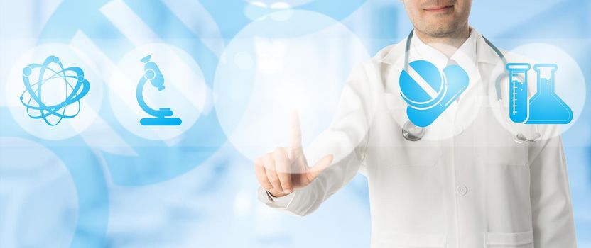 Medical Concept - Doctor points at copy space with icons showing symbol of research innovation for healthcare technology on blue abstract background.