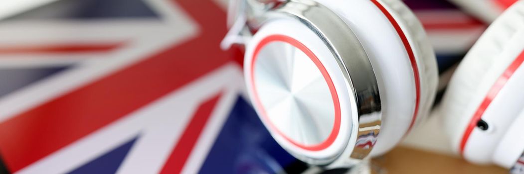 Headphones against the background of the flag of Great Britain, close-up. Education in Europe, exchange of experience. Language learning