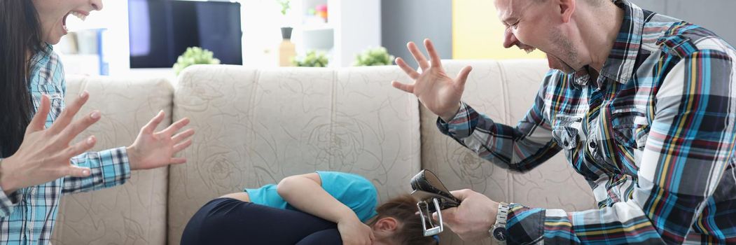 Dad and mom are shouting at their daughter at home, close-up. The child is afraid of punishment. Emotional domestic violence, aggressive parents