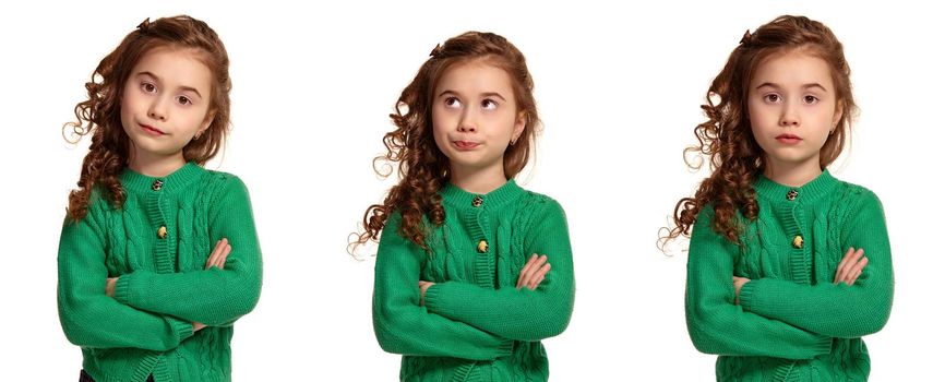 Close-up portrait of a beautiful curly little girl in a green knitted sweater looking unsatisfied while posing isolated on white background. Set of people sincere emotions, lifestyle concept. Mockup copy space.