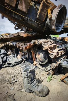 Kyiv region, Ukraine - May 15, 2022: War in Ukraine. Highway Kyiv - Zhytomyr. People take selfies against destroyed russian tank after russian atack in Febrary