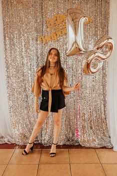 18th birthday girl with a balloon in her hand. Ukrainian young woman in a mini skirt. Fashion summer 2021 style glamorous. inscription: happy birthday