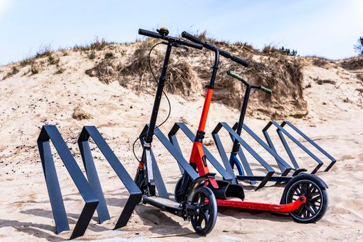 scooters parked on the beach parking lot in summer, eco-friendly transport, eco-friendly