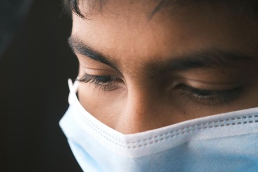 Close up of man with protective face mask looking at camera.