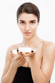 Beauty Youth Skin Care Concept - Close up Beautiful Caucasian Woman Face Portrait presenting cream jar for skin care over white background