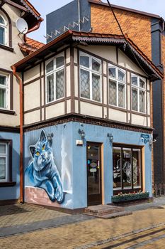 Zelenogradsk, Kaliningrad region, Russia - april 04 2022: An old European house with a large drawing with a blue cat on the wall.
