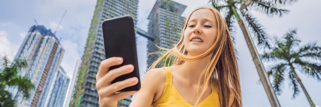 Woman Tourist using navigation app on the mobile phone. Navigation map on a smartphone in a big city. BANNER, LONG FORMAT