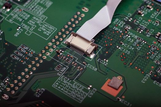 Electronic components. Integrated circuits, resistors, transistors and capacitors on PCB. Green copper board detail. Standard color code. Old computer hardware.