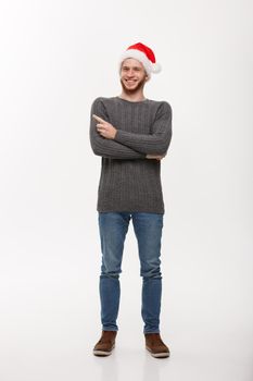 Holiday Concept - Young beard man in sweater enjoy playing and pointing finger onside with copyspace.