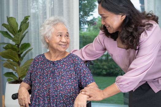 Help Asian senior or elderly old lady woman sitting on wheelchair and wearing a face mask for protect safety infection Covid 19 Coronavirus.