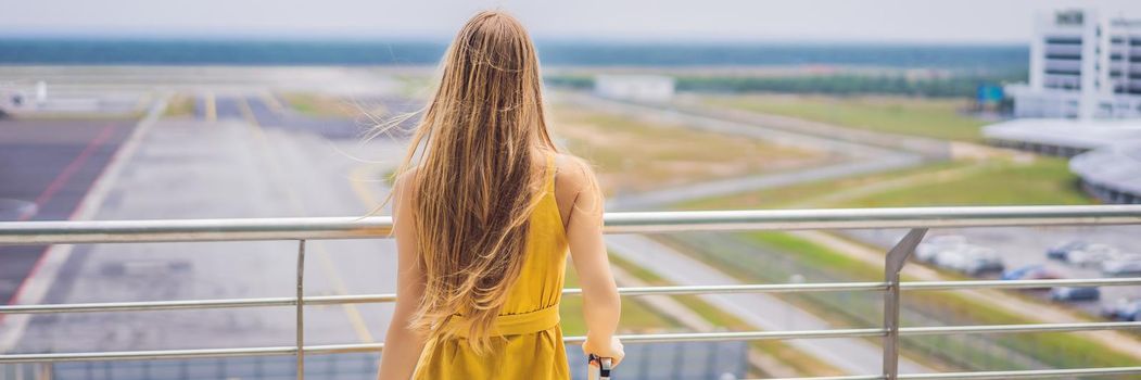 Start of her journey. Beautiful young woman ltraveler in a yellow dress and a yellow suitcase is waiting for her flight. BANNER, LONG FORMAT