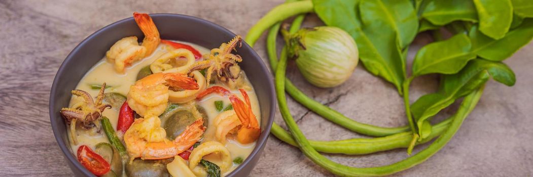 Thai food chicken green curry on dark wooden background. top view. BANNER, LONG FORMAT