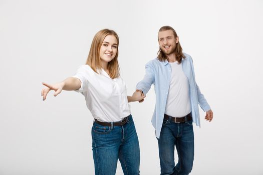 happy loving couple holding hands over white background.