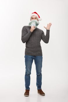 Holiday Concept - young beard man holding money in front over white background