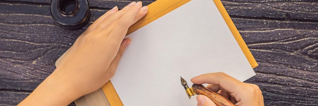 Women's hands in a wooden background holding a signboard, drawing block, paper, mockup. BANNER, LONG FORMAT