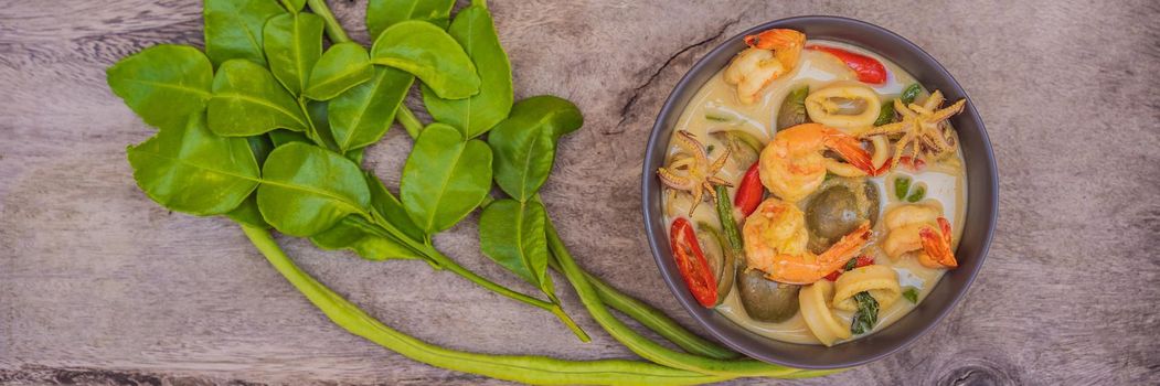 Thai food chicken green curry on dark wooden background. top view. BANNER, LONG FORMAT