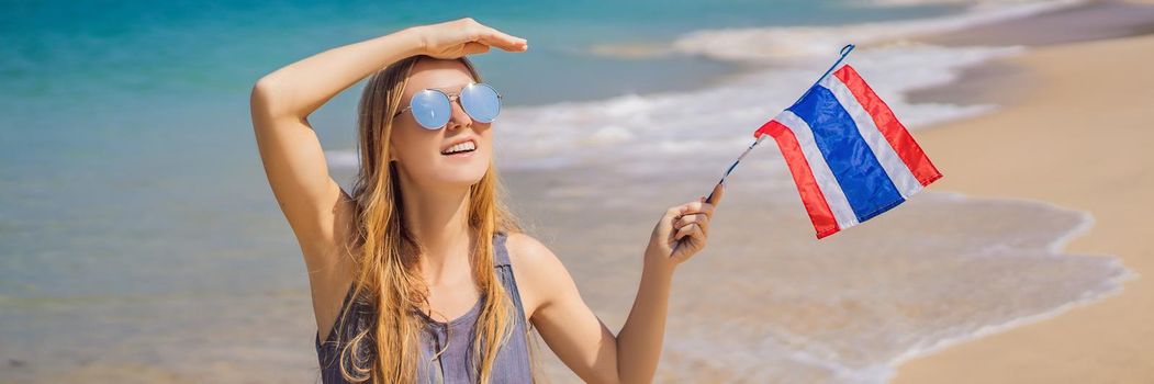 Happy woman having fun at the beach with Thailand flag. Beautiful girl enjoying travel to Asia. BANNER, LONG FORMAT