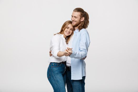 Young elegant couple in casual cloth dancing over Isolated on white studio background