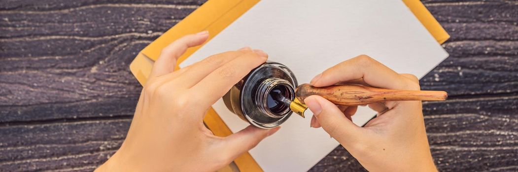 Women's hands in a wooden background holding a signboard, drawing block, paper, mockup. BANNER, LONG FORMAT