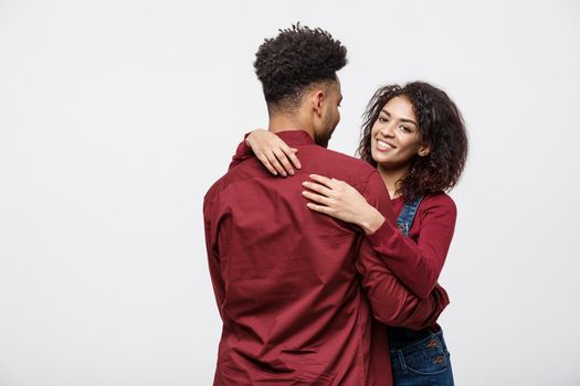 portrait of happy african american couple hug each other on white background