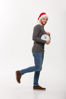 Rush time concept - Young beard smart man running with clock in busy moment over white studio.