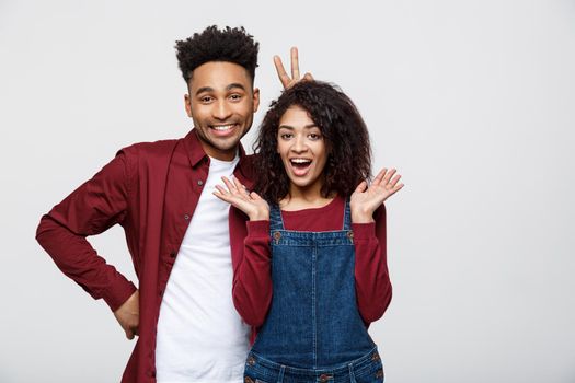 Happy young African couple dressed casually having fun together