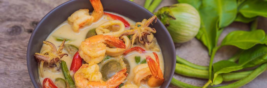 Thai food chicken green curry on dark wooden background. top view. BANNER, LONG FORMAT