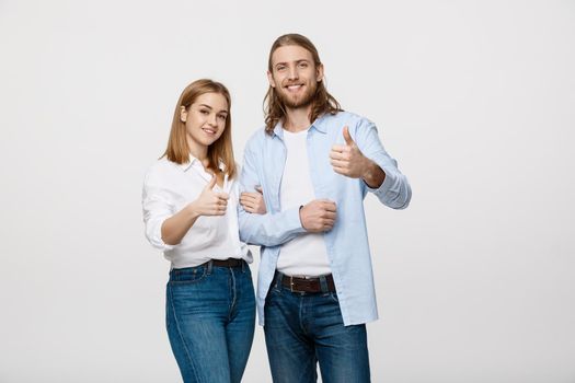 Portrait of Happy Young Couple Showing Thumb Up Isolated On White Background.