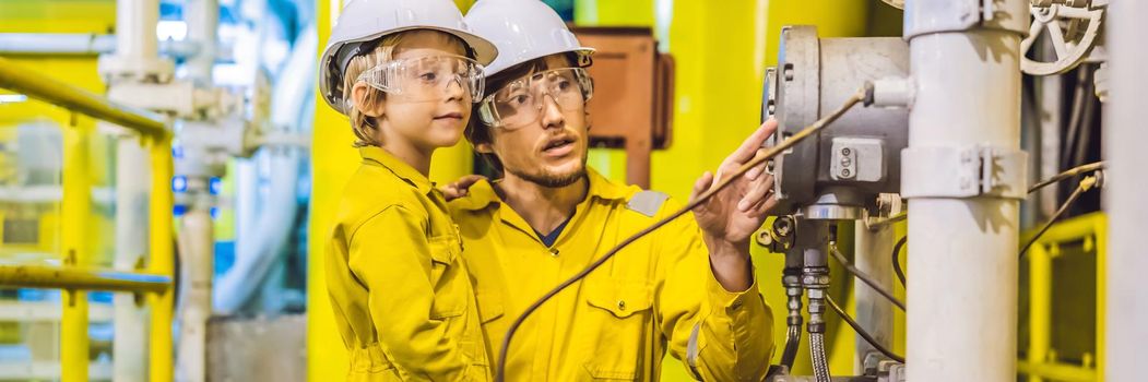 BANNER, LONG FORMAT Young man and a little boy are both in a yellow work uniform, glasses, and helmet in an industrial environment, oil Platform or liquefied gas plant.
