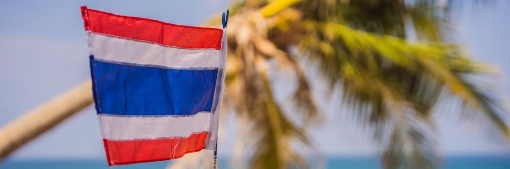 Waving Thailand flag in the sunny blue sky with summer beach background. Vacation theme, holiday concept. BANNER, LONG FORMAT