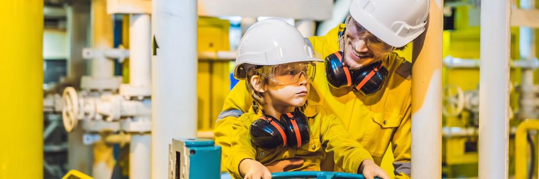 BANNER, LONG FORMAT Young man and a little boy are both in a yellow work uniform, glasses, and helmet in an industrial environment, oil Platform or liquefied gas plant.