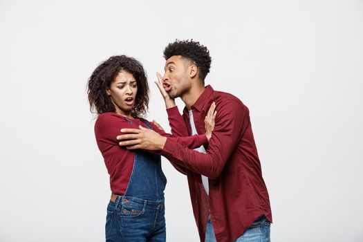 Close-up of African American young couple deny kissing over white background studio.