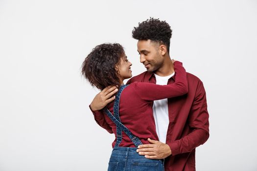 portrait of happy african american couple hug each other on white background