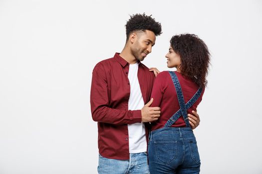 portrait of happy african american couple hug each other on white background