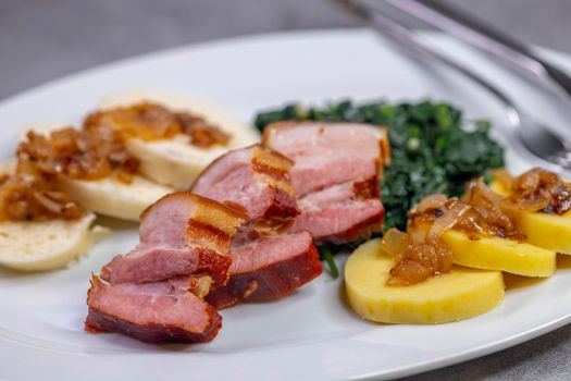 smoked flank with potato and bread dumplings and spinach