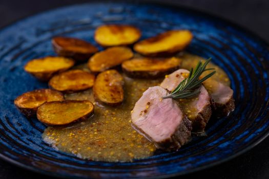 pork tenderloin with baked potatoes and French coarse mustard sauce