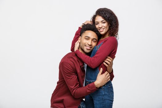 portrait of happy african american couple hug each other on white background