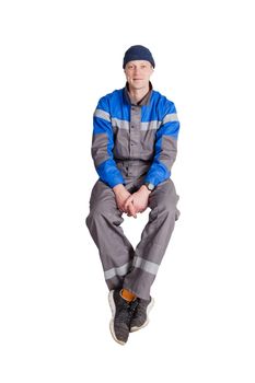 Portrait of a beautiful construction worker, foreman or repairman sitting in a white interior