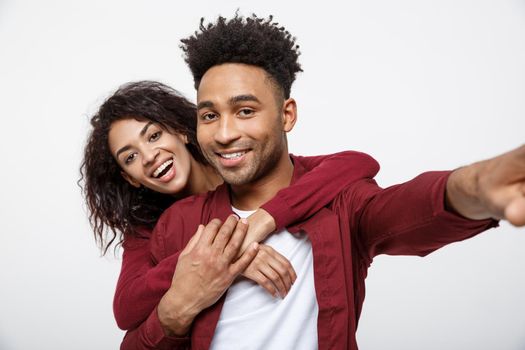 Close up attractive African American couple making a selfie with cute gesture