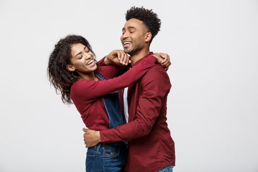 Close-up of African American young couple deny kissing over white background studio.